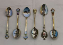 A set of six 800 silver enamelled decorated teaspoons