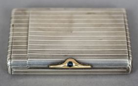 A Russian silver cigarette box Of ribbed rounded rectangular form with a cabochon inset gold clasp,