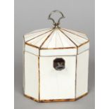 A George III tortoiseshell strung ivory tea caddy Of octagonal form, with brass loop handle.