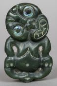 A Maori Hei Tiki pendant Of typical form, with abalone set eyes. 7.25 cm high.