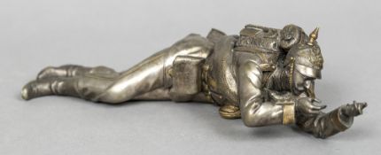 A Continental silver plated inkwell Modelled as a Prussian soldier in prone position. 28 cm long.