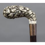 A 19th century Continental gold mounted carved ivory parasol/umbrella handle Profusely worked with