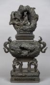 A 19th century Japanese patinated bronze censor The removable lid formed as a deity in a cave