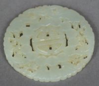A Chinese carved and pierced pale jade bi disc Typically worked. 5.5 cm diameter.