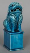 A Chinese porcelain temple lion Typically modelled with allover turquoise glaze. 19 cm high.