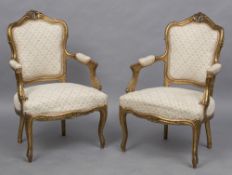 A pair of 19th century carved giltwood open armchairs Each florally carved pierced top rail above