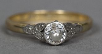 An 18 ct gold and platinum diamond solitaire ring The claw set stone approximately 0.5 carat.