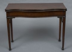 A George III mahogany serpentine top card table The baize lined folding shaped top above a plain