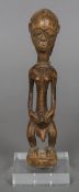 A 19th century African Senufo Tribe carved wood fertility figure Modelled as a man with woven