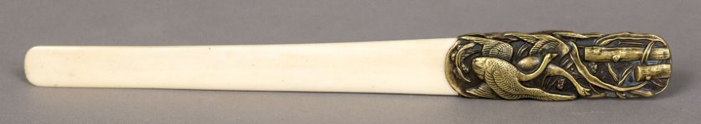 A late 19th century Japanese ivory bladed page turner The copper and brass handle decorated with