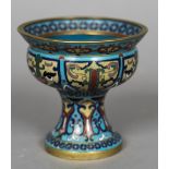 A 19th century Chinese cloisonne tazza The flared rim above the stylised face lappets,