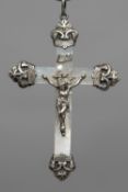 A late 19th century French unmarked silver mounted mother-of-pearl crucifix pendant Typically