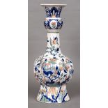A 19th century polychrome decorated fluted vase The white ground decorated with birds amongst