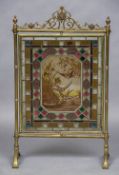 A Victorian brass framed stained leaded glass fire screen The pierced scrolling top rail above