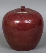 A Chinese porcelain ginger jar and cover With allover sang de boeuf glaze. 21.5 cm high.