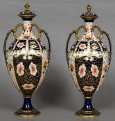 A pair of Royal Crown Derby porcelain vases and covers Each typically decorated in the Imari