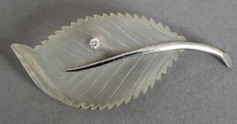 A 14 ct white gold, diamond set brooch Formed as a leaf. 15.75 cm wide.