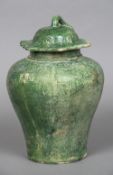 A Chinese pottery vase and cover Of baluster form, with allover green glaze,
