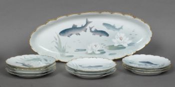 A J & C Kopenhagen part fish service Each plate decorated with a fish and water plants on a muted