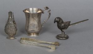 An Eastern silver model of a bird Together with a pair of Eastern silver sugar tongs;