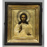 A yellow metal clad painted icon worked as Jesus Christ Housed in a glazed box frame.