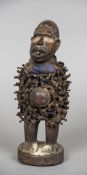 An African tribal fetish figure Carved wood set with nails. 26 cm high.