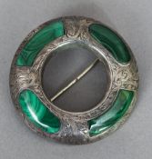 A Scottish unmarked silver malachite set brooch Of circular form;