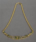 An 18 ct gold necklace Set with emeralds and diamonds. 40 cm long.