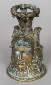 A 19th century bronze bell The handle formed as a laurel wreath above three classical busts.
