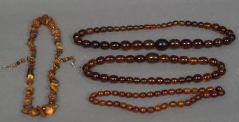 Four amber necklaces Three strung with polished beads, the other with natural stones.