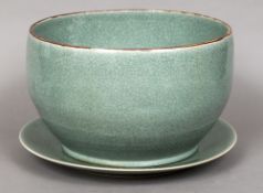 A large Chinese celadon ground bowl and stand Of plain form with an iron red rim. The bowl 41.