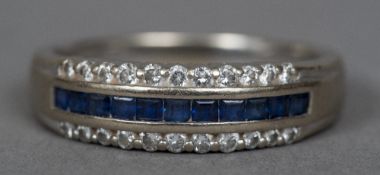 An 18 ct white gold diamond and sapphire ring Set with a central row of square set sapphires