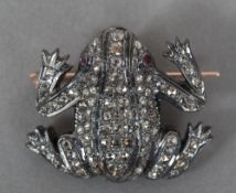 A yellow metal and silver diamond and ruby set brooch Formed as a frog. 3.5 cm wide.
