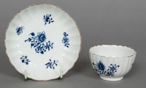 An 18th century Lowestoft porcelain tea bowl and saucer Both with scalloped rim and ribbed body,