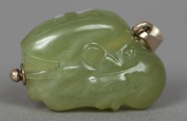 A small Chinese jade pebble Carved as a leopard on a rock. 3.5 cm high.