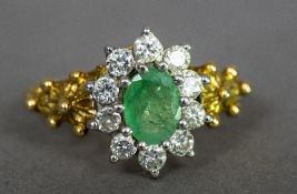 An 18 ct gold diamond and emerald cluster ring Of flowerhead form.