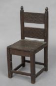 A 17th century oak child's chair, possibly American With carved back and solid seat. 78 cm high.