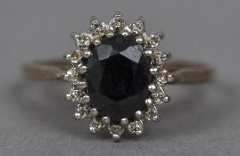 A 9 ct gold sapphire and diamond cluster ring Central facet cut sapphire flanked by a row of claw