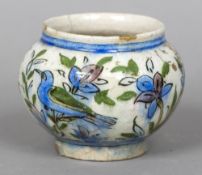 A 19th century Qajar pottery bowl Decorated in the round with birds amongst flowers. 10 cm high.