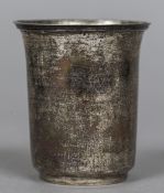 A Continental white metal beaker Of plain form, with reeded flared rim,