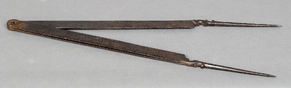 A pair of large early iron dividers, possibly related to shipping or tunnel excavation 72 cm long.