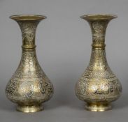 A pair of 19th century Eastern brass vases Each with unmarked silver and copper inlaid decorations.