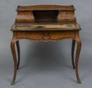 A 19th century French kingwood bonheur du jour The three quartered galleried top section above four