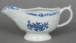 An 18th century Lowestoft porcelain gravy boat The moulded body printed with floral sprays.