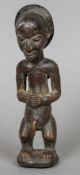 An African carved tribal figure Modelled as a naked male. 24 cm high.