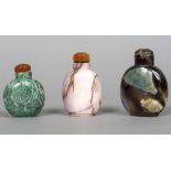 Three Chinese hardstone snuff bottles and stoppers The largest 8 cm high.