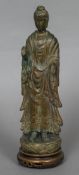 A Chinese bronzed terracotta model of Guanyin Modelled standing, on associated wooden base.