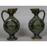 A pair of 19th century Turkish Chenakale Province pottery ewers With allover green lustre glaze