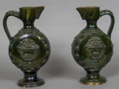 A pair of 19th century Turkish Chenakale Province pottery ewers With allover green lustre glaze