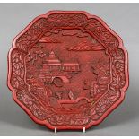 A 19th century or earlier Chinese red cinnabar lacquer plate Worked with two figures on a bridge